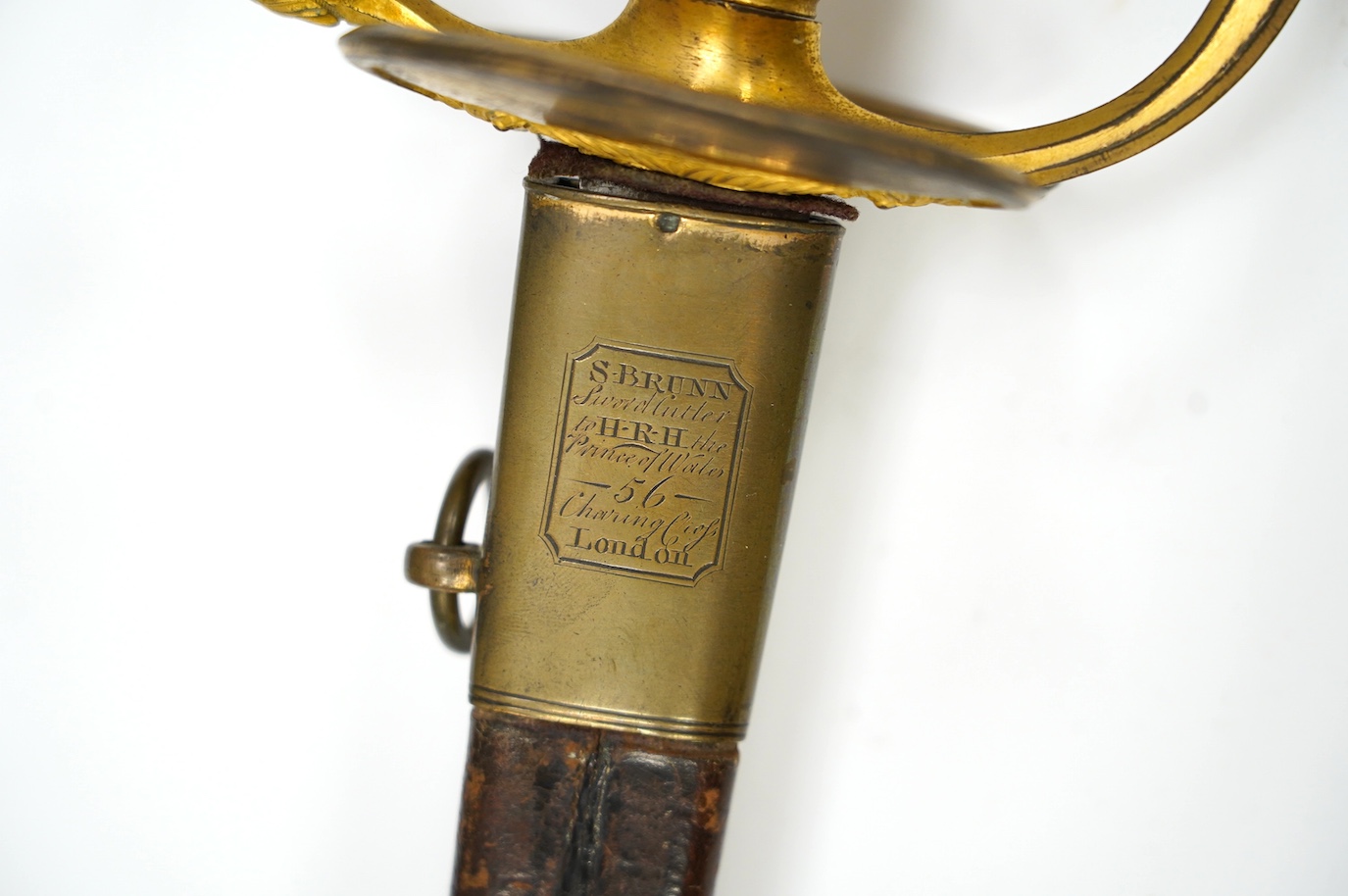 A 1796 pattern infantry officer's sword, blued and gilt blade, etched with crowned GR and Royal Arms, regulation gilt brass hilt, in its leather scabbard with brass mounts, locket signed S. Brunn, 81.5cm. Condition - goo